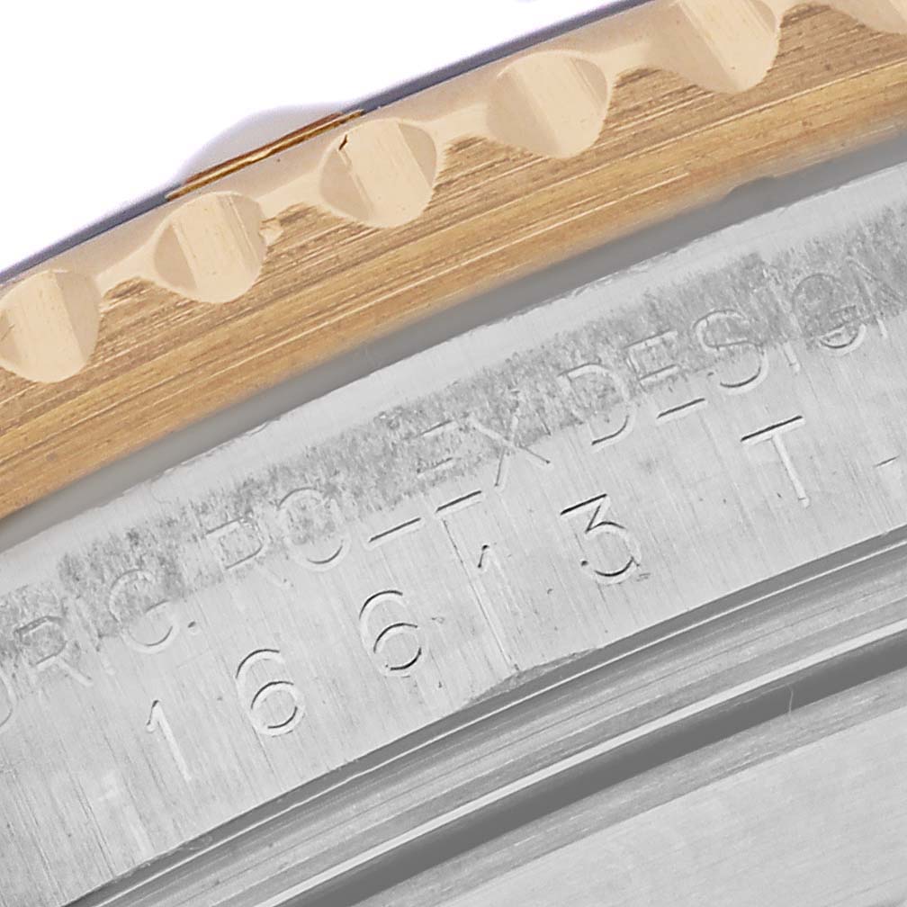 This close-up angle shows the engraved inner bezel and the edge of the outer bezel of the Rolex Submariner 16613 Men's Steel and Gold (two tone) Blue Dial 16613 Men's Steel and Gold (two tone) Blue Dial watch.