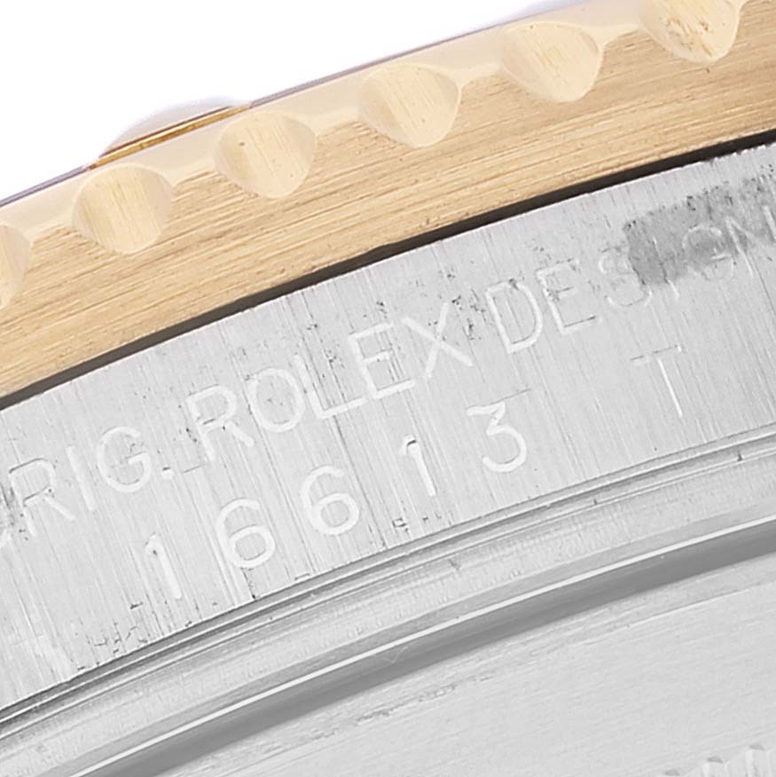The image shows a close-up of the side edge of a Rolex Submariner 16613 Men's Steel and Gold (two tone) Blue Dial 16613 Men's Steel and Gold (two tone) Blue Dial watch case with visible engraved model number.