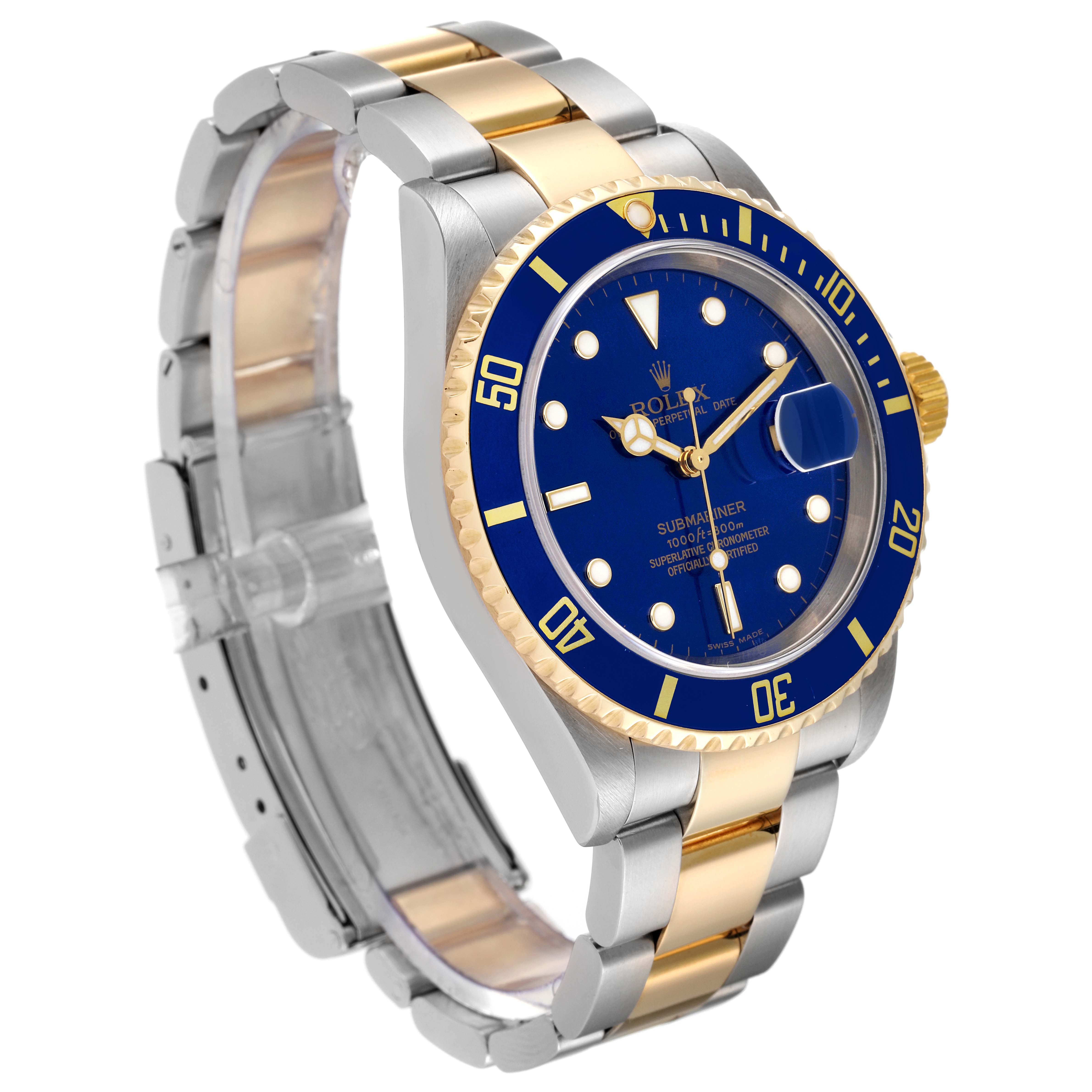 The image shows a Rolex Submariner 16613 Men's Steel and Gold (two tone) Blue Dial 16613 Men's Steel and Gold (two tone) Blue Dial watch at a three-quarter angle, highlighting its blue dial, bezel, and two-tone metal bracelet.