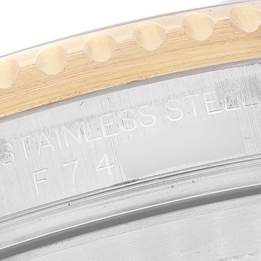 This image shows a close-up of the bezel and part of the case back of a Rolex Submariner 16613 Men's Steel and Gold (two tone) Blue Dial 16613 Men's Steel and Gold (two tone) Blue Dial watch, highlighting the edge and engraving.