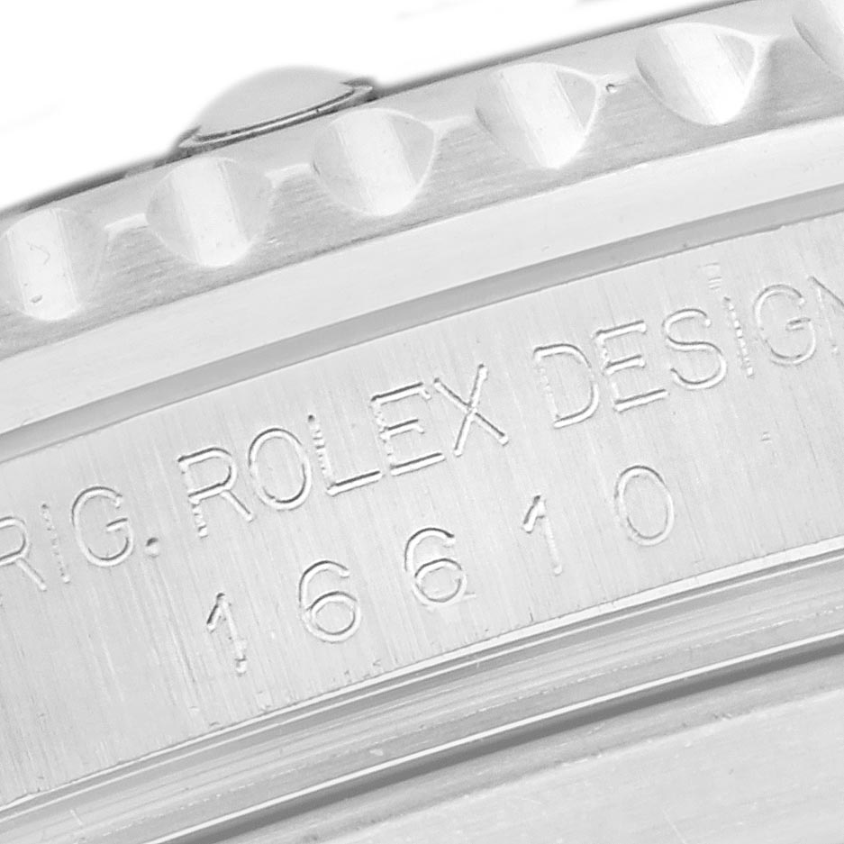 The image shows a close-up of the bezel and engraved case side of the Rolex Submariner 16610 Men's Stainless Steel Black Dial 16610 Men's Stainless Steel Black Dial model 16610.