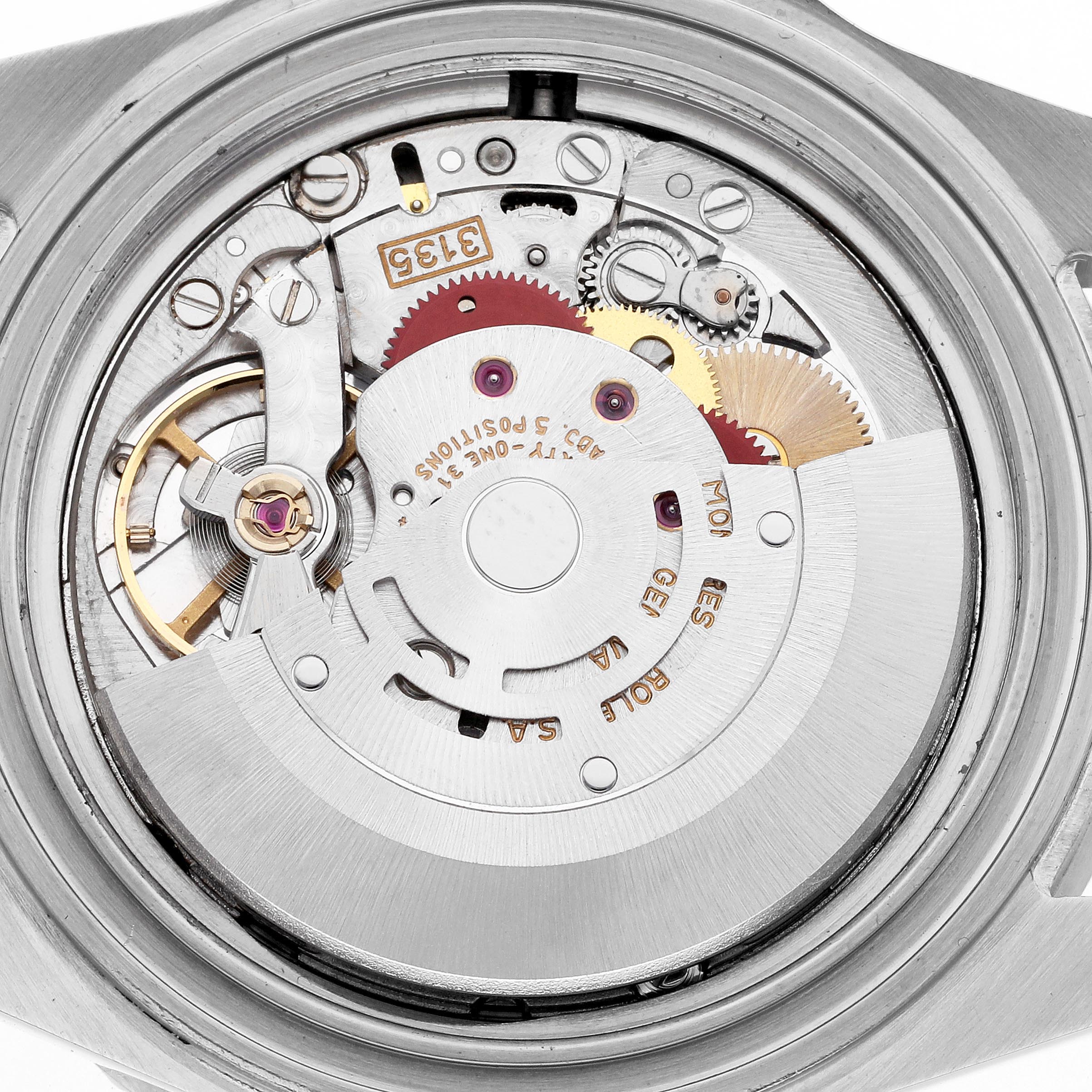 The image shows the internal mechanism of a Rolex Submariner 16610 Men's Stainless Steel Black Dial 16610 Men's Stainless Steel Black Dial watch, highlighting gears and the rotor from the back.