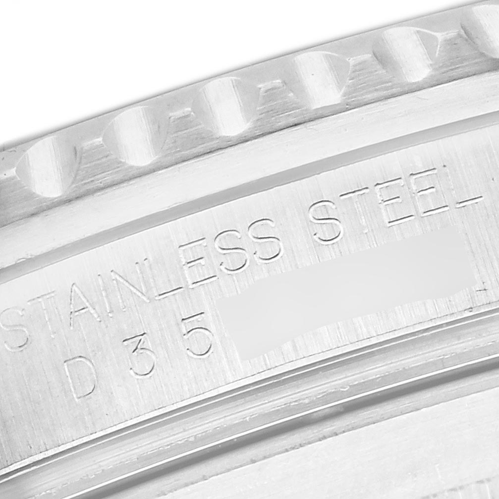 The image shows a close-up of the engraving on the side of the bezel and case of a Rolex Submariner 16610 Men's Stainless Steel Black Dial 16610 Men's Stainless Steel Black Dial, highlighting "STAINLESS STEEL".