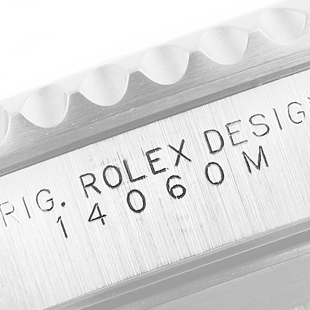 This close-up image shows the side engraving of the Rolex Submariner 14060M Men
s Stainless Steel Black Dial 14060M Men
s Stainless Steel Black Dial model, detailing "ROLEX DESIGN 14060M."