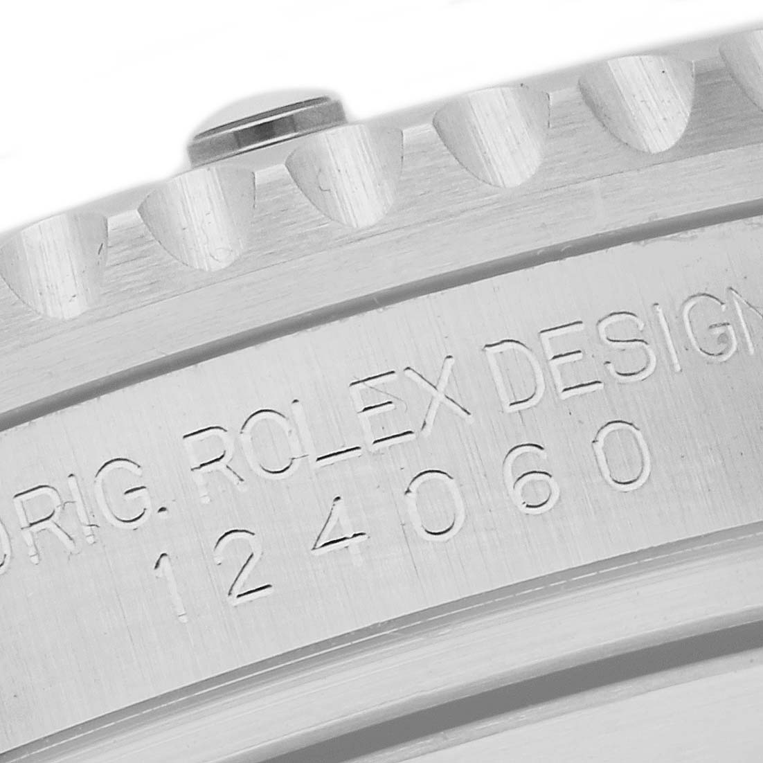 This image shows a close-up view of the engraved serial number and design details on the bezel edge of a Rolex Submariner 124060 Men
s Stainless Steel Black Dial 124060 Men
s Stainless Steel Black Dial.