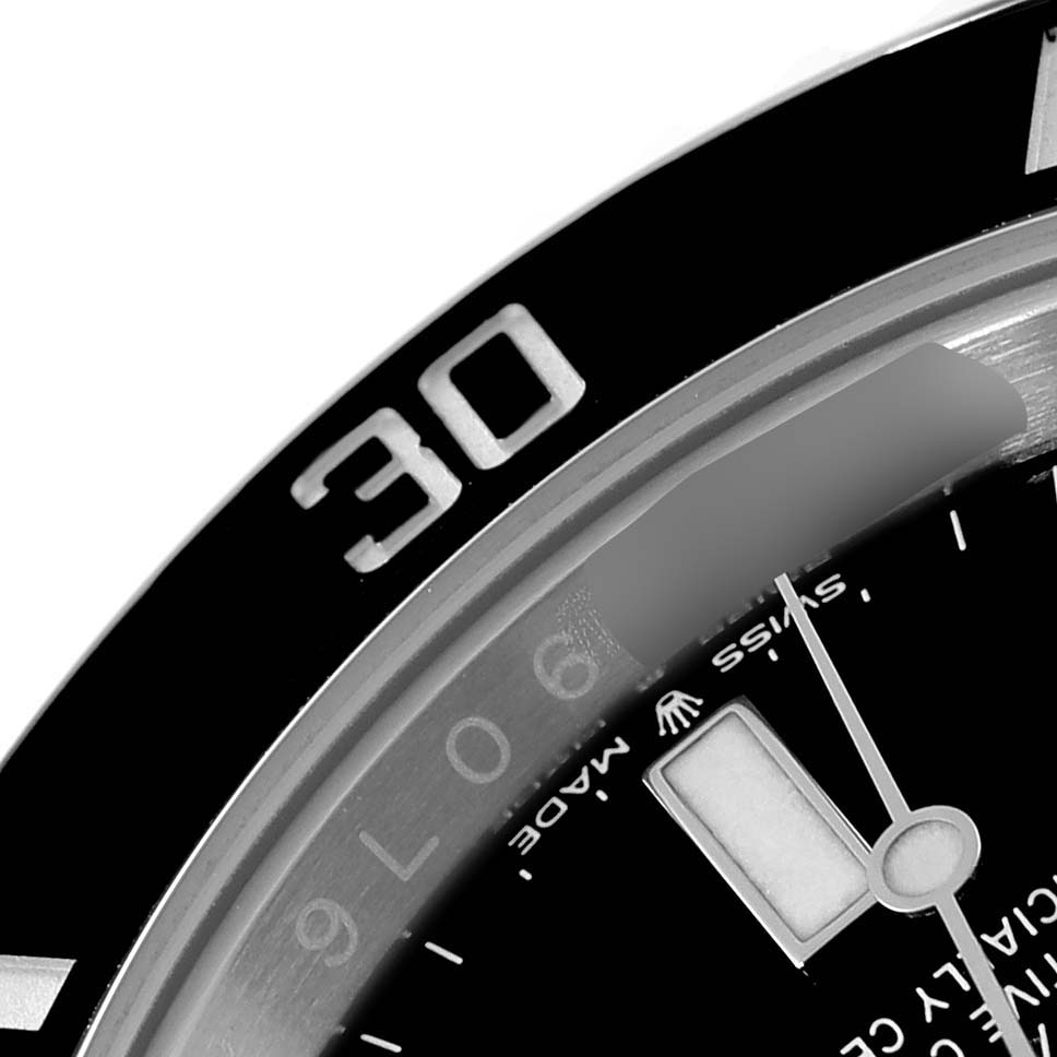 The image shows a close-up angle of the Rolex Submariner 124060 Men
s Stainless Steel Black Dial 124060 Men
s Stainless Steel Black Dial
s bezel and part of the dial and hands.