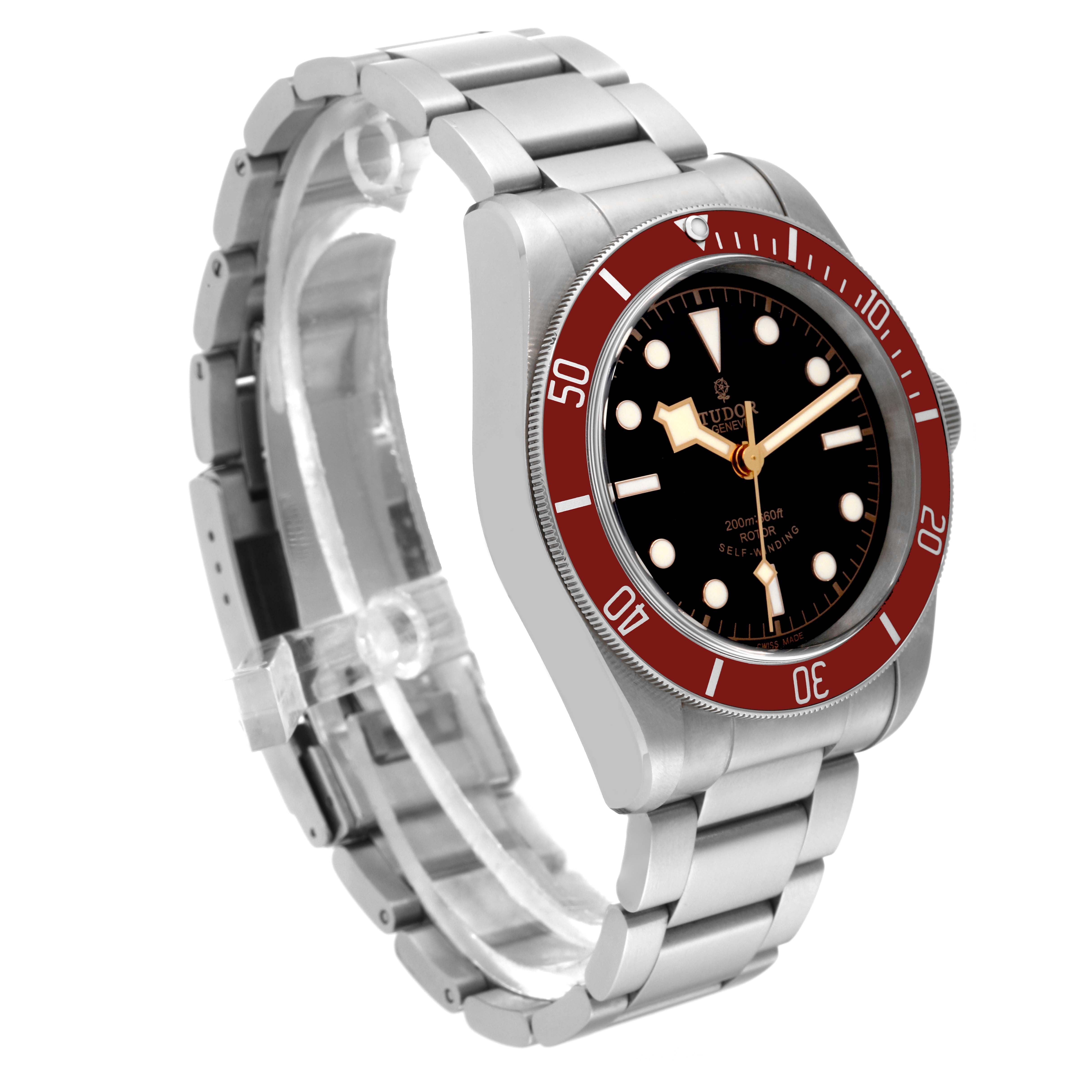 This image shows the Tudor Heritage Black Bay 79220R Men
s Stainless Steel Black Dial 79220R Men
s Stainless Steel Black Dial watch at a three-quarter angle, highlighting its metal bracelet and red bezel.