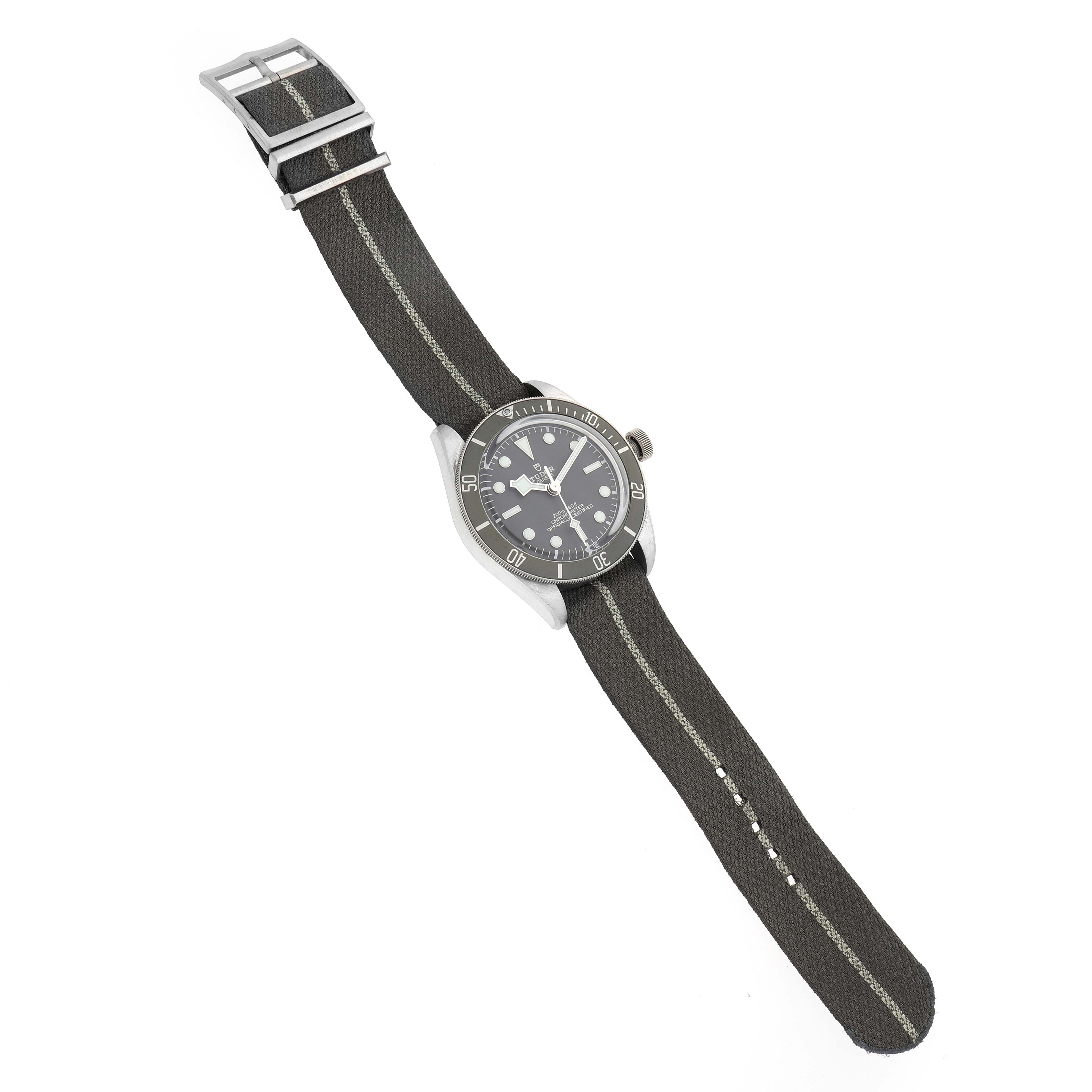 The Tudor Heritage Black Bay 79010 Men
s Stainless Steel Grey Dial 79010 Men
s Stainless Steel Grey Dial watch is shown at a slight angle, displaying the face, bezel, and fabric strap.