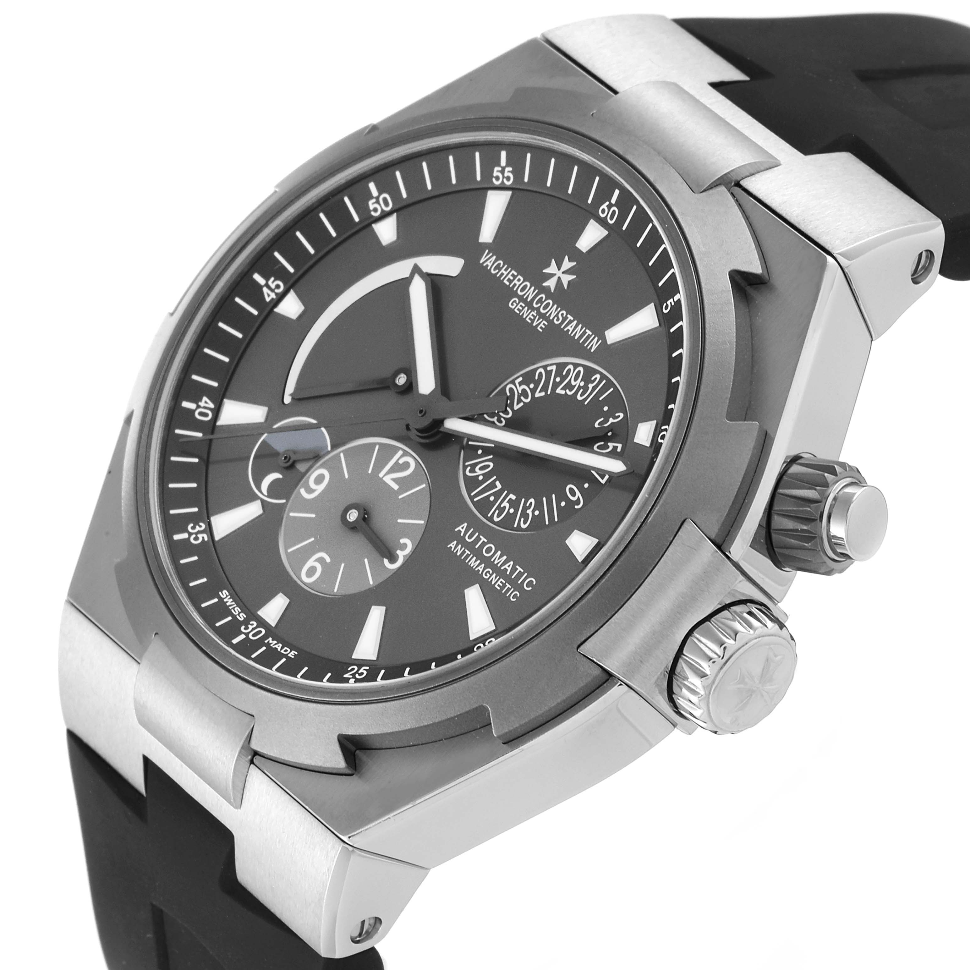 The image shows a close-up angled view of a Vacheron Constantin Overseas 47450/000W-9511 Men's Stainless Steel Grey Dial 47450/000W-9511 Men's Stainless Steel Grey Dial watch, focusing on the dial and crown.