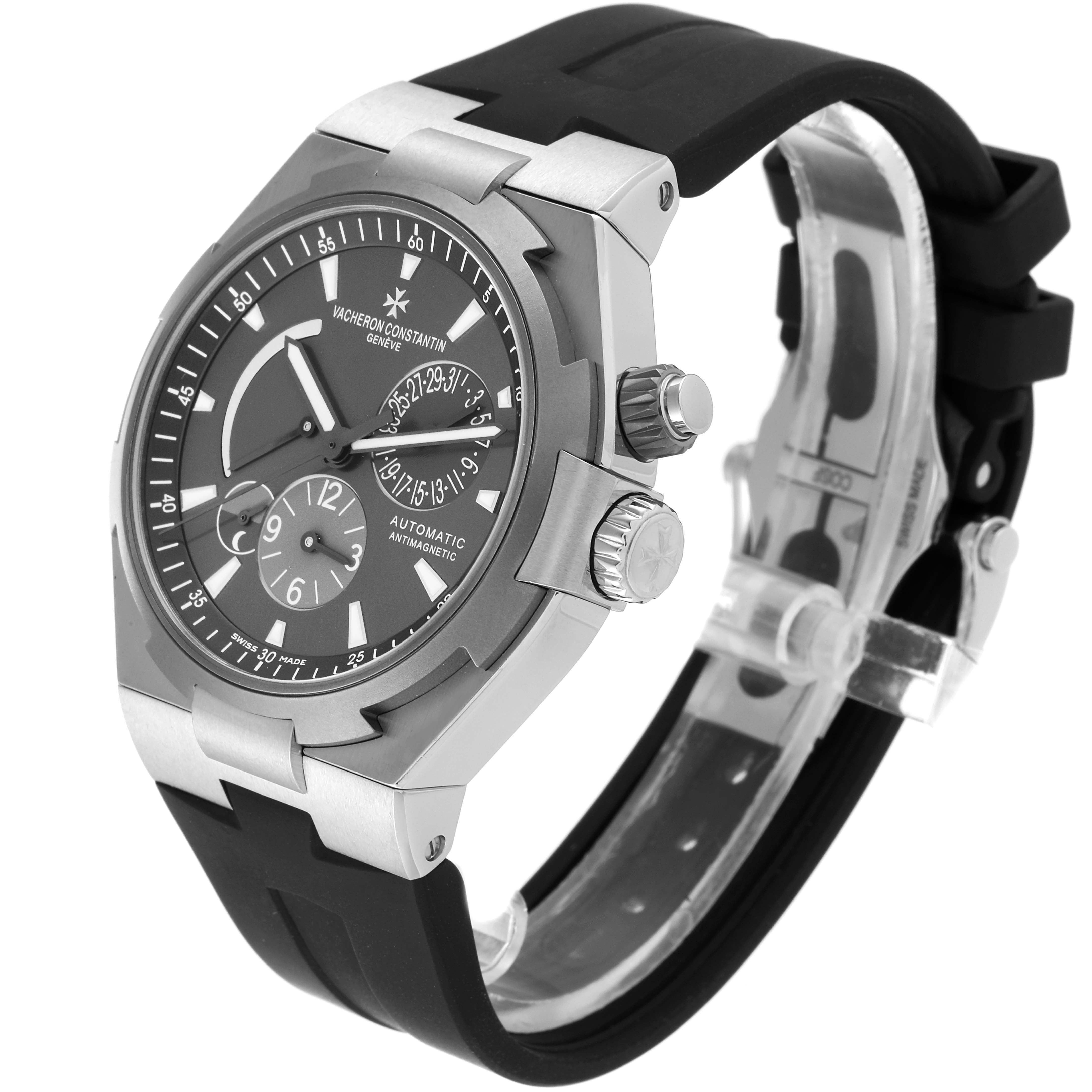 The Vacheron Constantin Overseas 47450/000W-9511 Men's Stainless Steel Grey Dial 47450/000W-9511 Men's Stainless Steel Grey Dial watch is shown at a three-quarter angle, highlighting its face, case, and rubber strap.