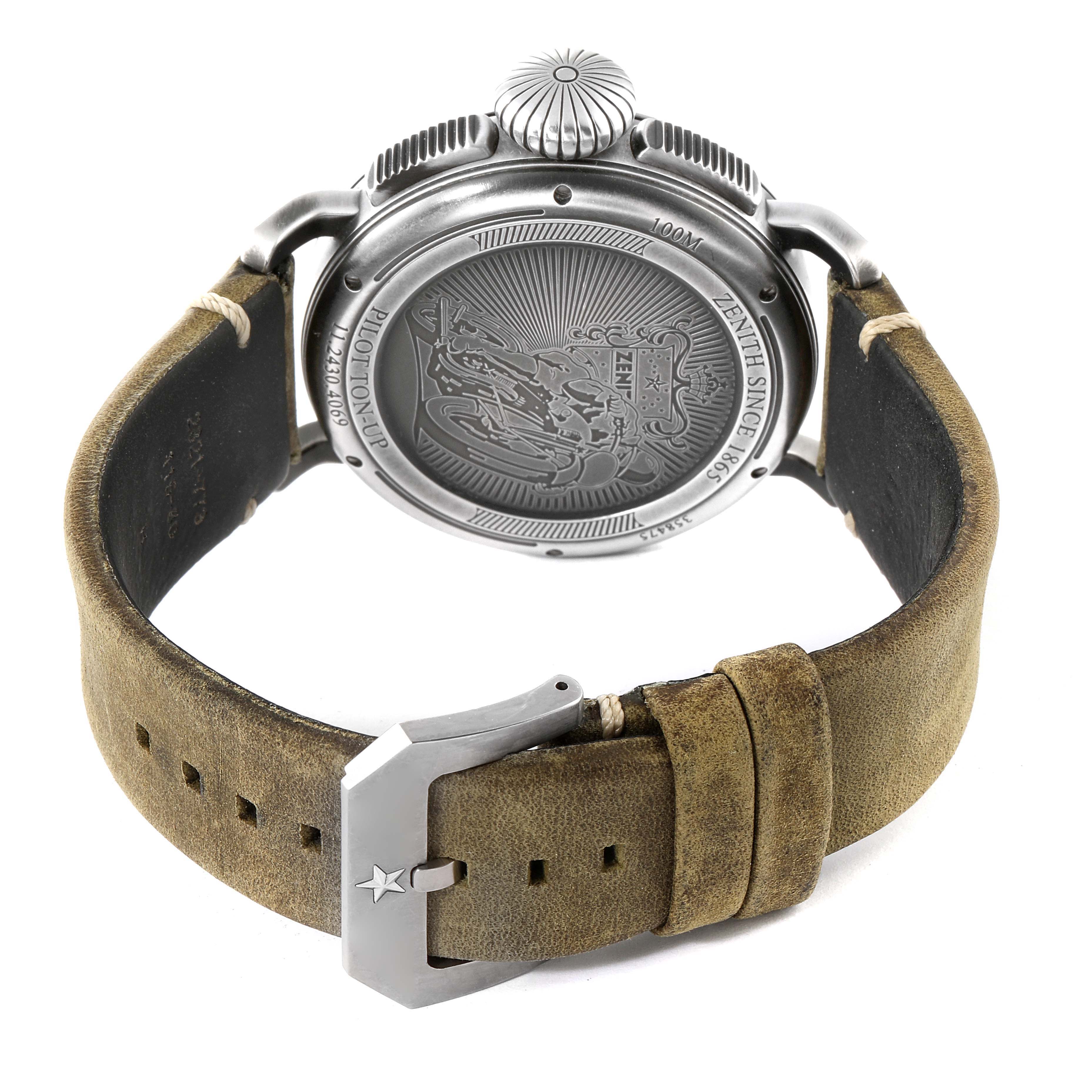 The Zenith Pilot 11.2430.4069/21.C773 Men's Stainless Steel Grey Dial 11.2430.4069/21.C773 Men's Stainless Steel Grey Dial model watch is shown from the back, displaying its engraved case back, crown, and leather strap with a star-imprinted buckle.