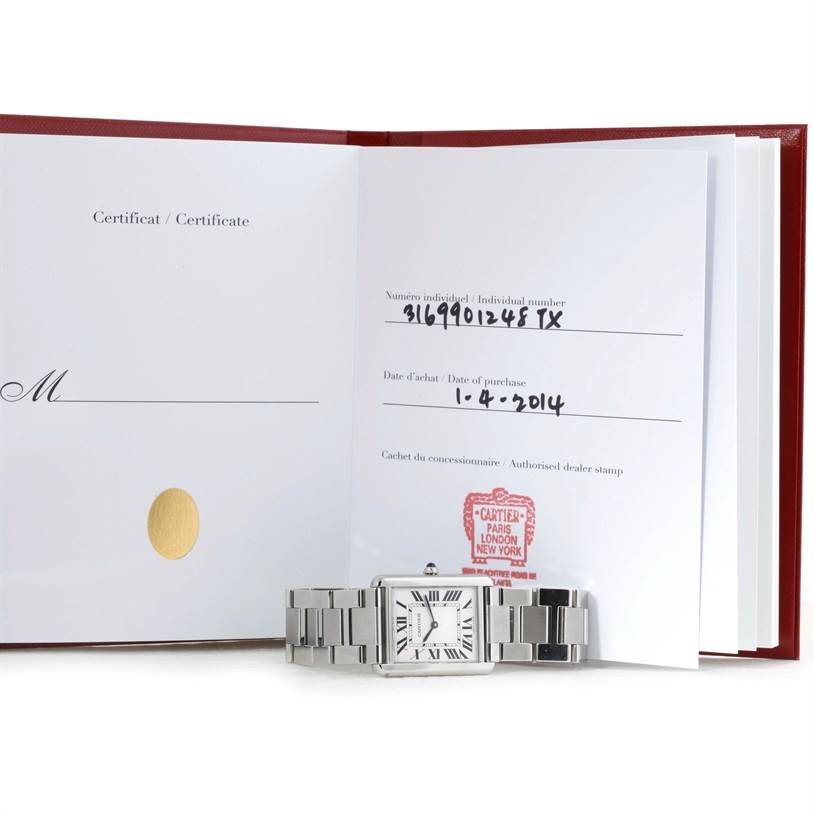 The image shows a Cartier Tank Solo W5200014 Men's Stainless Steel Silver Dial W5200014 Men's Stainless Steel Silver Dial watch laid flat in front of an open certificate book displaying purchase details.