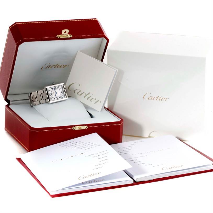The image shows a Cartier Tank Solo W5200014 Men's Stainless Steel Silver Dial W5200014 Men's Stainless Steel Silver Dial watch in its red presentation box, with accompanying booklets and packaging.