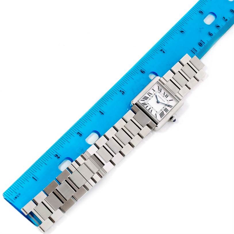 The Cartier Tank Solo W5200014 Men's Stainless Steel Silver Dial W5200014 Men's Stainless Steel Silver Dial watch is shown from a top-down angle alongside a blue ruler for scale.