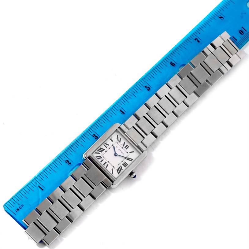 This image shows the entire Tank Solo model by Cartier, viewed from above, laying next to a ruler for measurement.