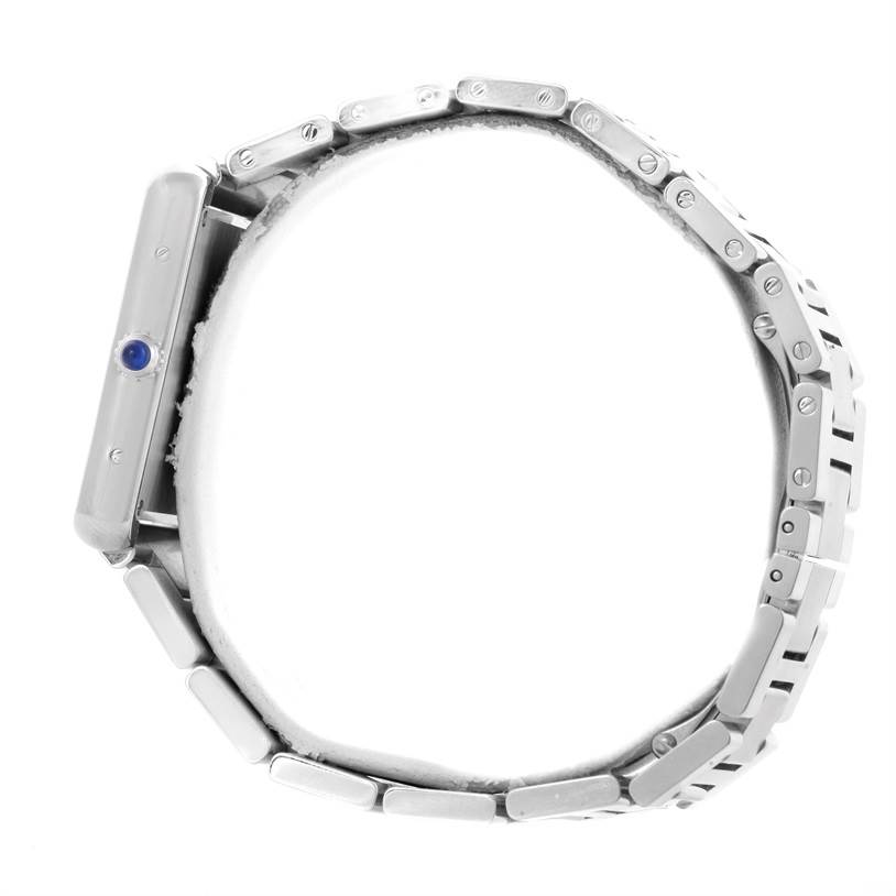 The Tank Solo by Cartier is shown from a side angle, highlighting the watch case, crown, and metal bracelet links.