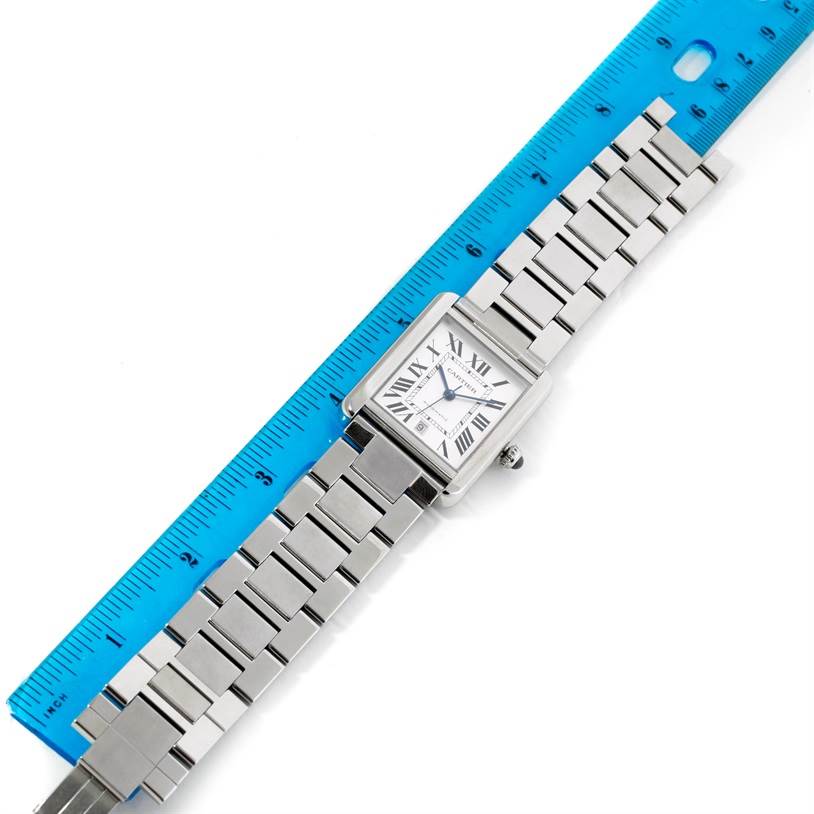 The image shows the Cartier Tank Solo W5200028 Men
s Stainless Steel Silver Dial W5200028 Men
s Stainless Steel Silver Dial watch with a stainless steel strap next to a blue ruler for size reference.