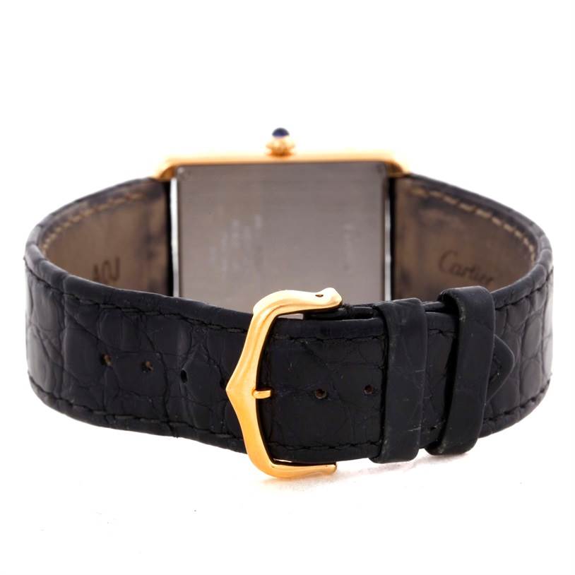 The image shows the back view of a Cartier Tank Solo W1018855 Men
s Steel and Gold (two tone) Silver Dial W1018855 Men
s Steel and Gold (two tone) Silver Dial watch with its leather strap and gold buckle visible.