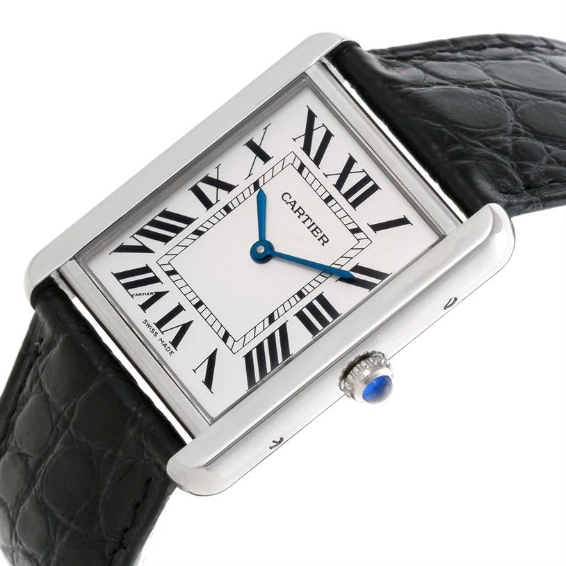 The Cartier Tank Solo W1018355 Men
s Stainless Steel Silver Dial W1018355 Men
s Stainless Steel Silver Dial watch is shown at an angle, highlighting its rectangular face, black leather strap, and blue hands.