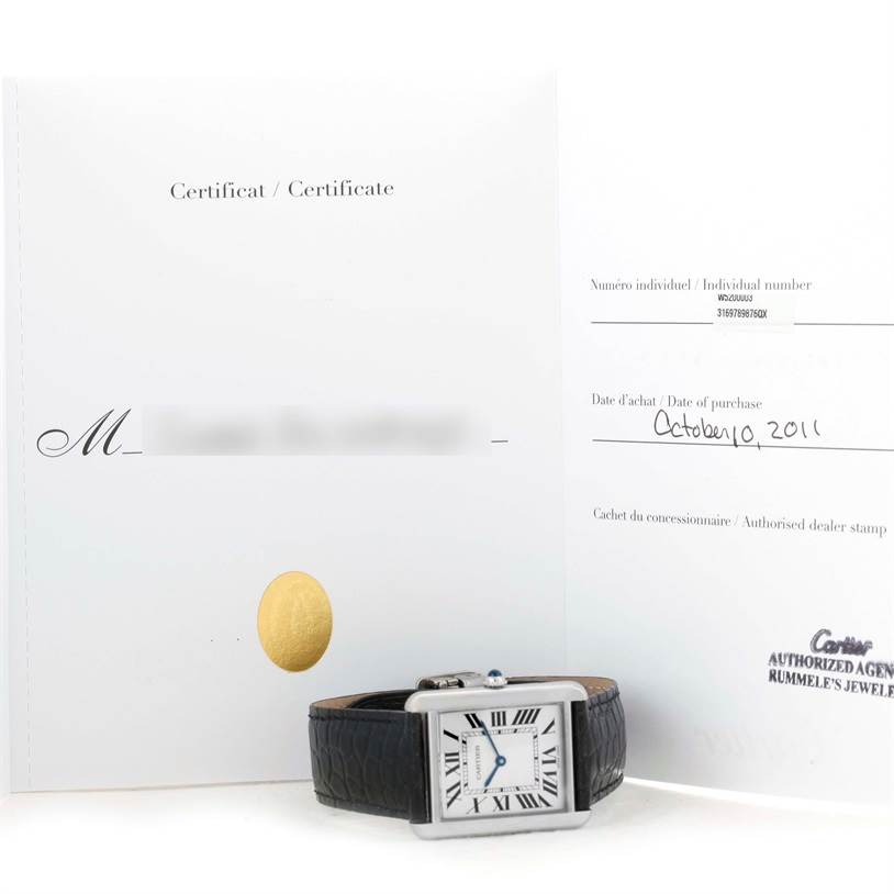 The image shows a Cartier Tank Solo W1018355 Stainless Steel Silver Dial W1018355 Stainless Steel Silver Dial watch and its certificate, both partially visible, with the watch laid flat.