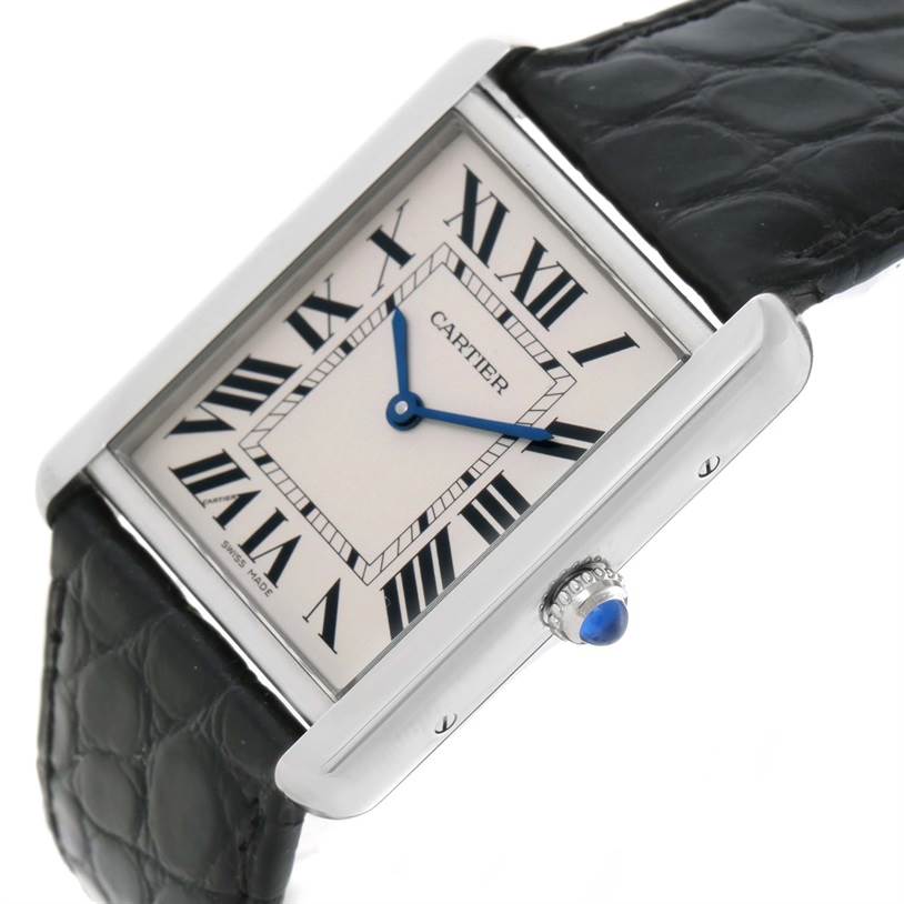 The Cartier Tank Solo W1018355 Men's Stainless Steel Silver Dial W1018355 Men's Stainless Steel Silver Dial watch is shown at a slight angle, highlighting its rectangular face, Roman numeral indices, blue hands, and leather strap.