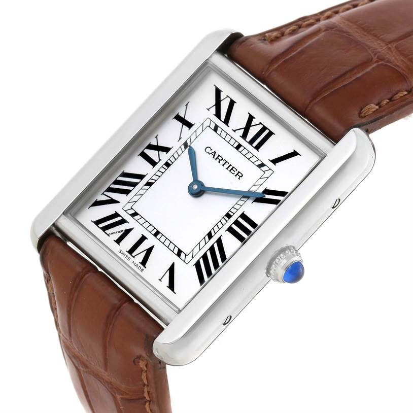 The Cartier Tank Solo W1018355 Men
s Stainless Steel Silver Dial W1018355 Men
s Stainless Steel Silver Dial watch is shown at an angled view displaying the face, crown, and part of the brown leather strap.