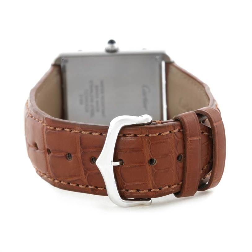 The image shows the backside of a Cartier Tank Solo W1018355 Men
s Stainless Steel Silver Dial W1018355 Men
s Stainless Steel Silver Dial watch, highlighting its brown leather strap and silver buckle.