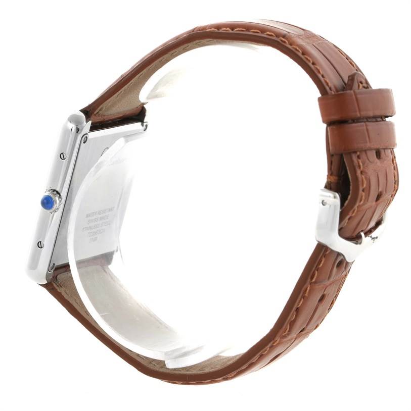 The image shows a side view of the Cartier Tank Solo W1018355 Men
s Stainless Steel Silver Dial W1018355 Men
s Stainless Steel Silver Dial watch, highlighting its brown leather strap and a sapphire cabochon crown.