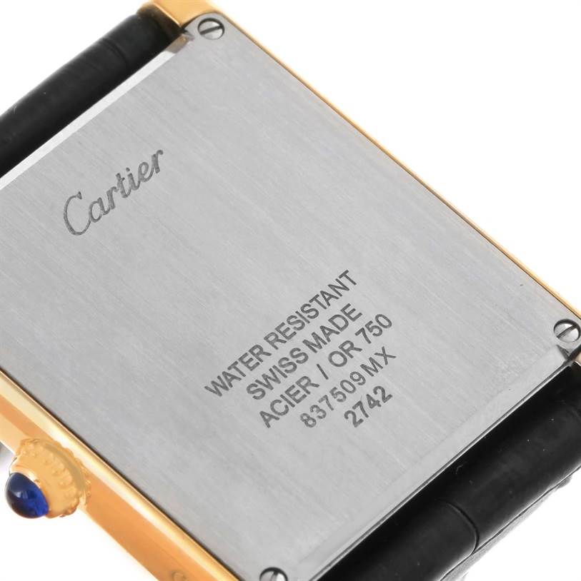 This image shows the back case of a Cartier Tank Solo W1018855 Men
s Steel and Gold (two tone) Silver Dial W1018855 Men
s Steel and Gold (two tone) Silver Dial watch, including the crown and part of the leather strap.