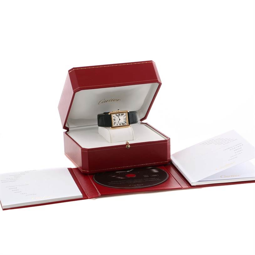 The Cartier Tank Solo W1018855 Men
s Steel and Gold (two tone) Silver Dial W1018855 Men
s Steel and Gold (two tone) Silver Dial watch is displayed in its box, alongside manuals and a CD, viewed from a front angle.