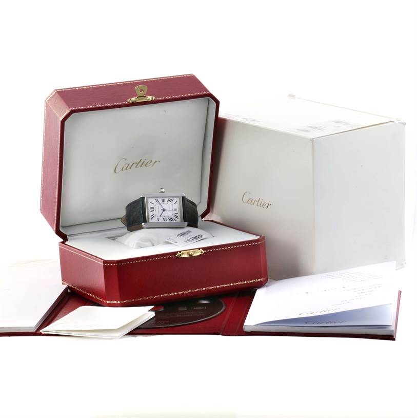 The Cartier Tank Solo W5200027 Men
s Stainless Steel Silver Dial W5200027 Men
s Stainless Steel Silver Dial watch is angled front-on, placed inside an open display box, alongside its packaging and documentation.