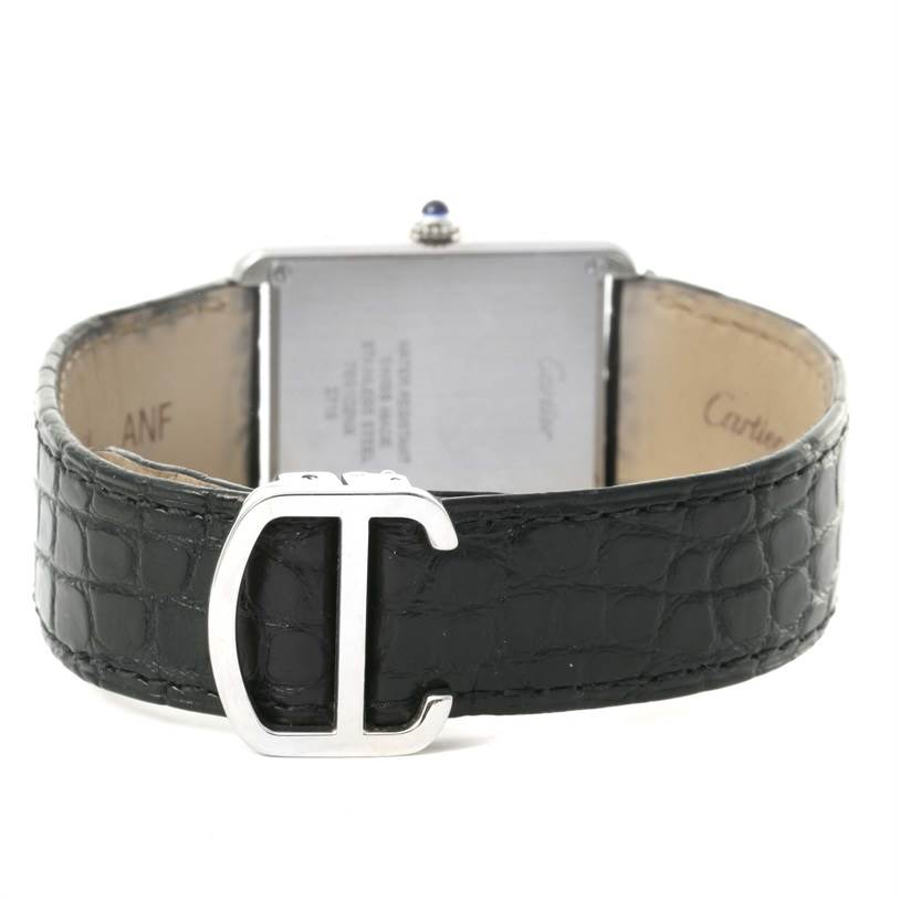 This image shows the back view of a Cartier Tank Solo W1018355 Stainless Steel Silver Dial W1018355 Stainless Steel Silver Dial watch with a close-up of its black leather strap and silver buckle.