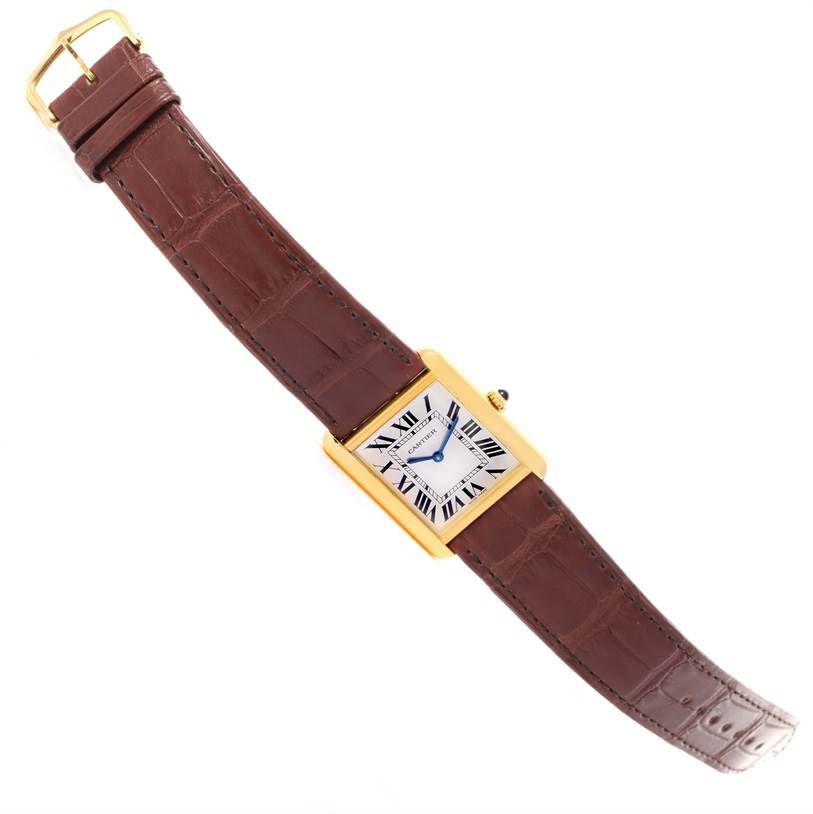 This Cartier Tank Solo W1018855 Men
s Steel and Gold (two tone) Silver Dial W1018855 Men
s Steel and Gold (two tone) Silver Dial watch is shown from a top-down angle, displaying the entire face and brown leather strap.