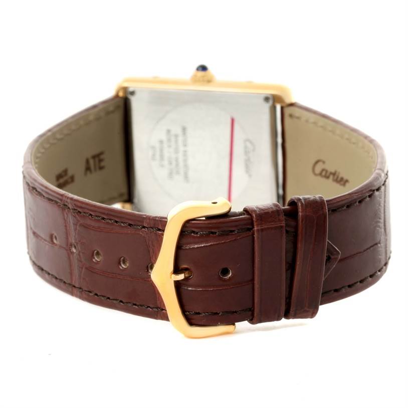 The image shows the back view of a Cartier Tank Solo W1018855 Men
s Steel and Gold (two tone) Silver Dial W1018855 Men
s Steel and Gold (two tone) Silver Dial watch, focusing on the leather strap, buckle, and the case back.