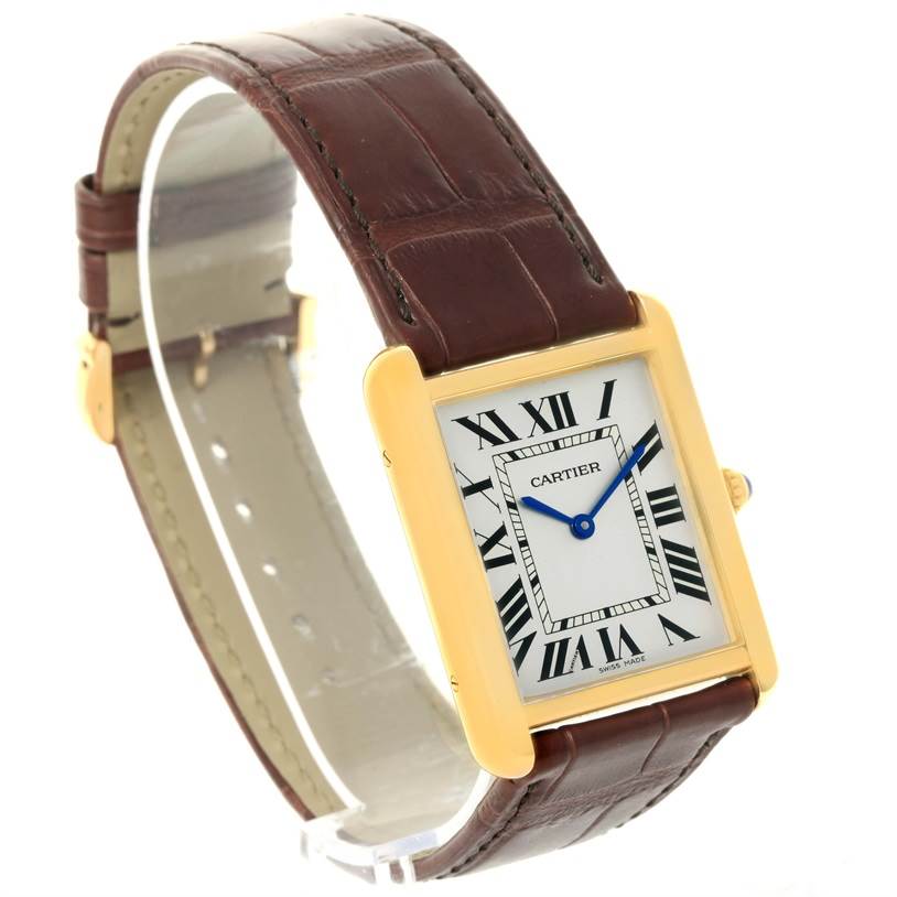 This image shows a side-angle view of a Cartier Tank Solo W1018855 Men
s Steel and Gold (two tone) Silver Dial W1018855 Men
s Steel and Gold (two tone) Silver Dial watch, highlighting its rectangular face, gold bezel, and brown leather strap.