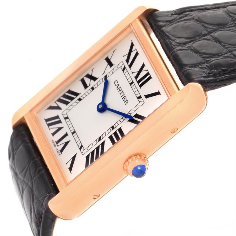 This image shows a Cartier Tank Solo W5200025 Steel and Gold (two tone) Silver Dial W5200025 Steel and Gold (two tone) Silver Dial watch at an angled view, highlighting its face, blue hands, Roman numerals, crown, and black leather strap.