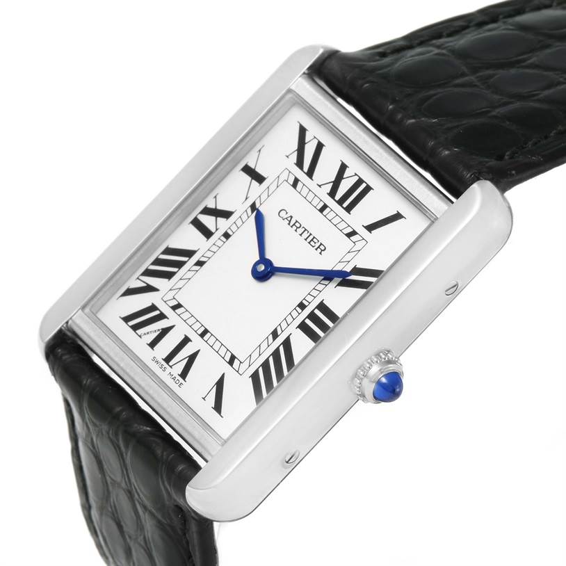 This image shows a Cartier Tank Solo W1018355 Men
s Stainless Steel Silver Dial W1018355 Men
s Stainless Steel Silver Dial watch at an oblique angle, highlighting the dial, case, crown with blue cabochon, and black leather strap.