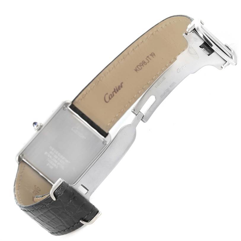 The Cartier Tank Solo W1018355 Men
s Stainless Steel Silver Dial W1018355 Men
s Stainless Steel Silver Dial watch is shown from the back, with the leather strap and clasp fully extended.