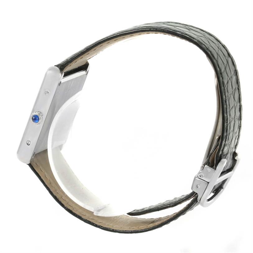 Side profile of a Cartier Tank Solo W1018355 Men
s Stainless Steel Silver Dial W1018355 Men
s Stainless Steel Silver Dial watch, showing the case, crown, and leather strap with buckle.
