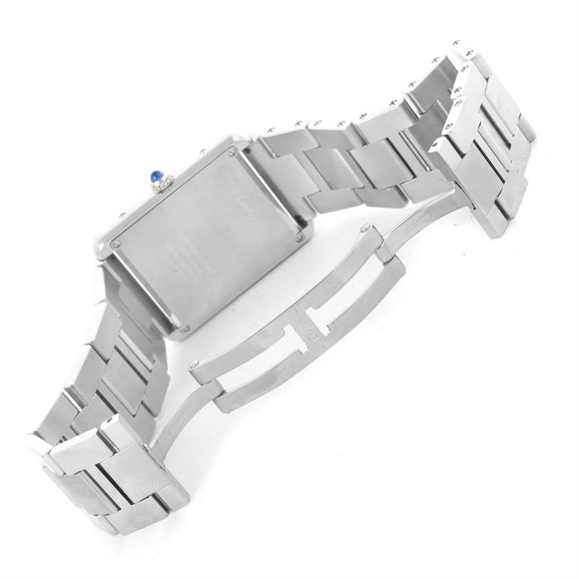 The image shows the underside of a Cartier Tank Solo W5200014 Men
s Stainless Steel Silver Dial W5200014 Men
s Stainless Steel Silver Dial watch with its stainless steel bracelet and deployment clasp.