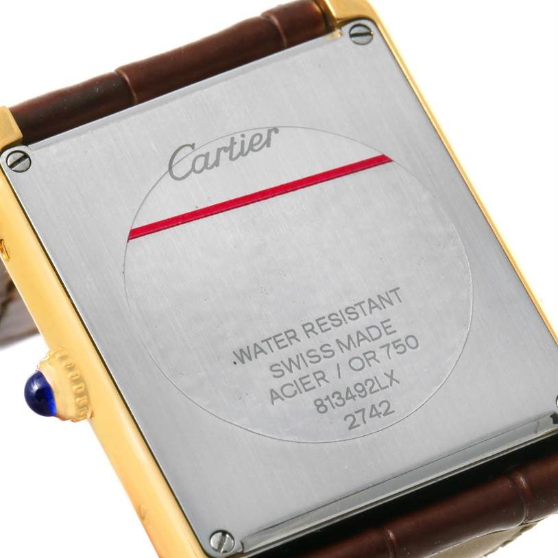 The image shows the back case of the Cartier Tank Solo W1018855 Men
s Steel and Gold (two tone) Silver Dial W1018855 Men
s Steel and Gold (two tone) Silver Dial watch, highlighting the engraving and details.