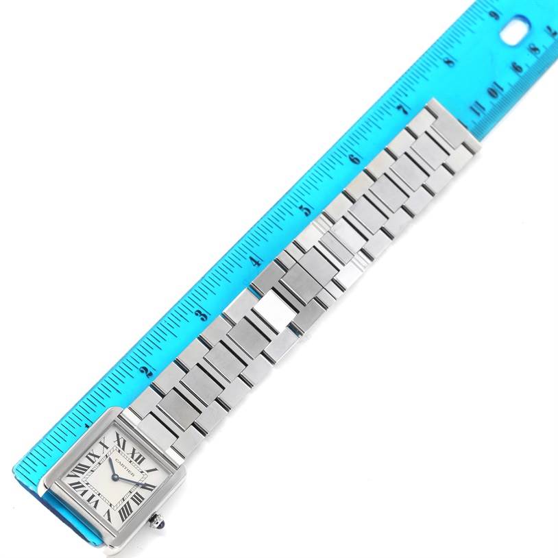 The image shows a Cartier Tank Solo W5200014 Men
s Stainless Steel Silver Dial W5200014 Men
s Stainless Steel Silver Dial watch laid flat next to a ruler, highlighting its bracelet length.