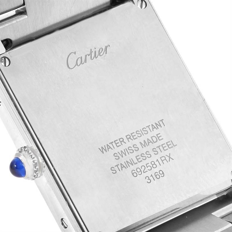 The image depicts the back case and the crown with a blue cabochon of a Cartier Tank Solo W5200014 Men
s Stainless Steel Silver Dial W5200014 Men
s Stainless Steel Silver Dial watch, showing the engraved model details.