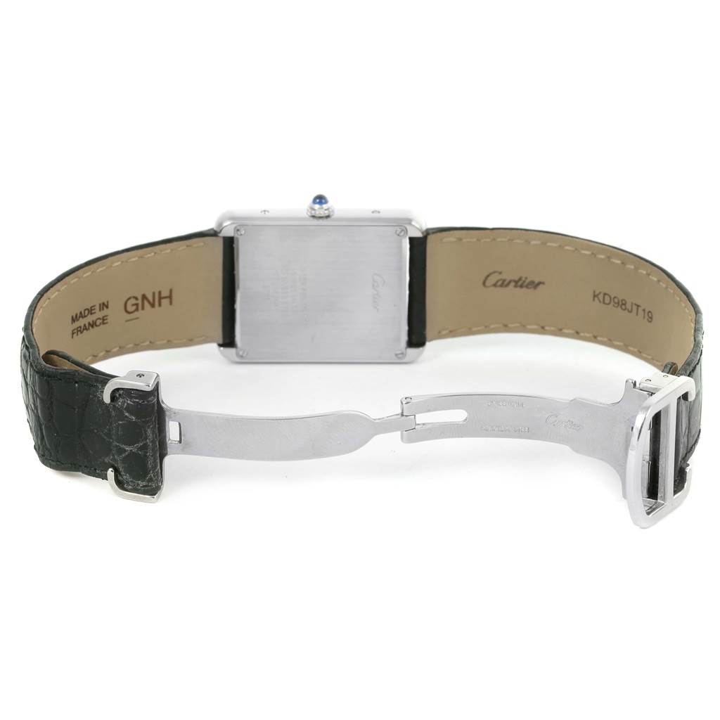 The image shows the underside of a Cartier Tank Solo W1018355 Men
s Stainless Steel Silver Dial W1018355 Men
s Stainless Steel Silver Dial watch, focusing on the back case and the leather strap with deployment clasp.