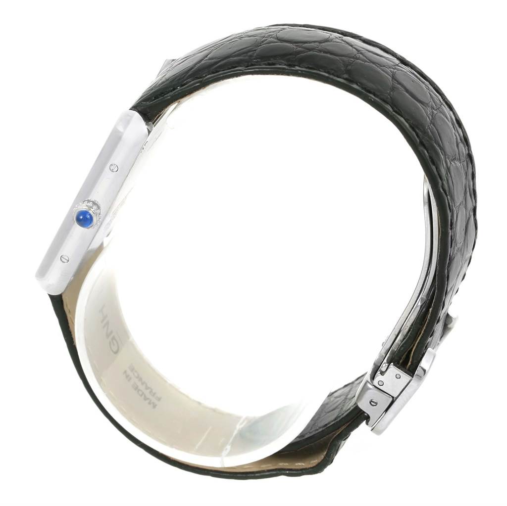 The image shows a side view of a Cartier Tank Solo W1018355 Men
s Stainless Steel Silver Dial W1018355 Men
s Stainless Steel Silver Dial watch, highlighting the crown with a blue cabochon and the leather strap.