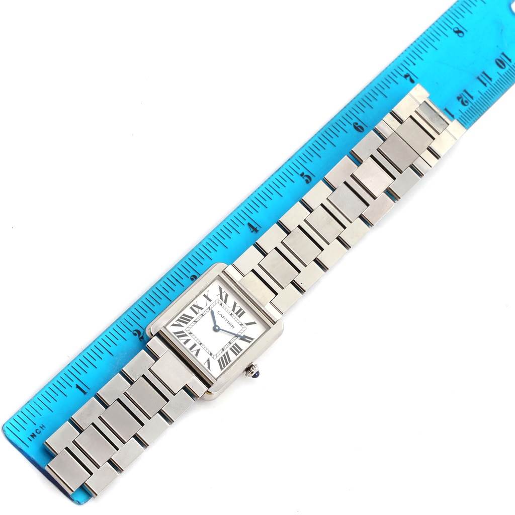 The image shows a top-down view of a Cartier Tank Solo W5200014 Men
s Stainless Steel Silver Dial W5200014 Men
s Stainless Steel Silver Dial watch, including the face, bracelet, and a ruler for scale.