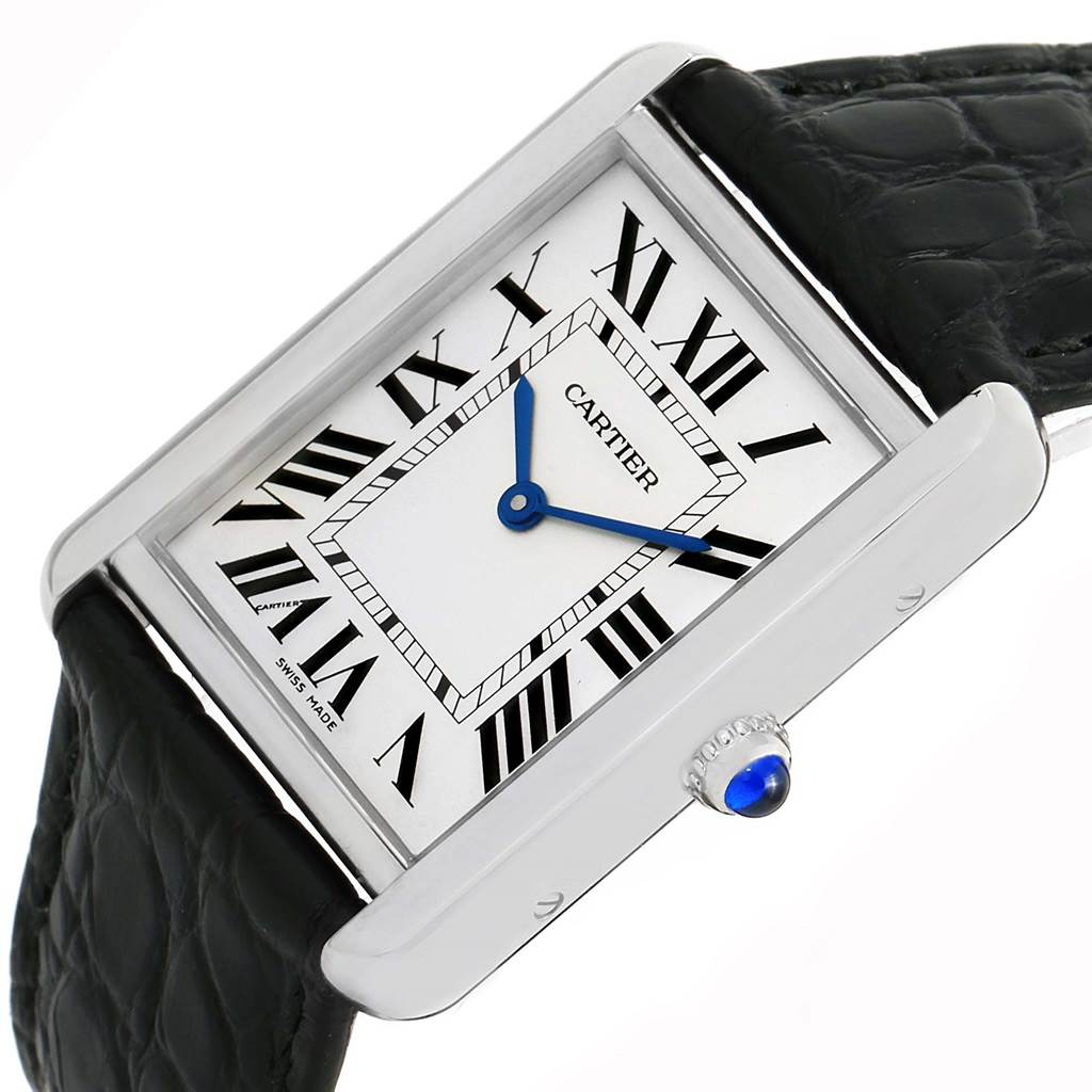 The image shows a Cartier Tank Solo W1018355 Stainless Steel Silver Dial W1018355 Stainless Steel Silver Dial watch at an angle, highlighting its face, Roman numerals, blue hands, and a part of its black leather strap.