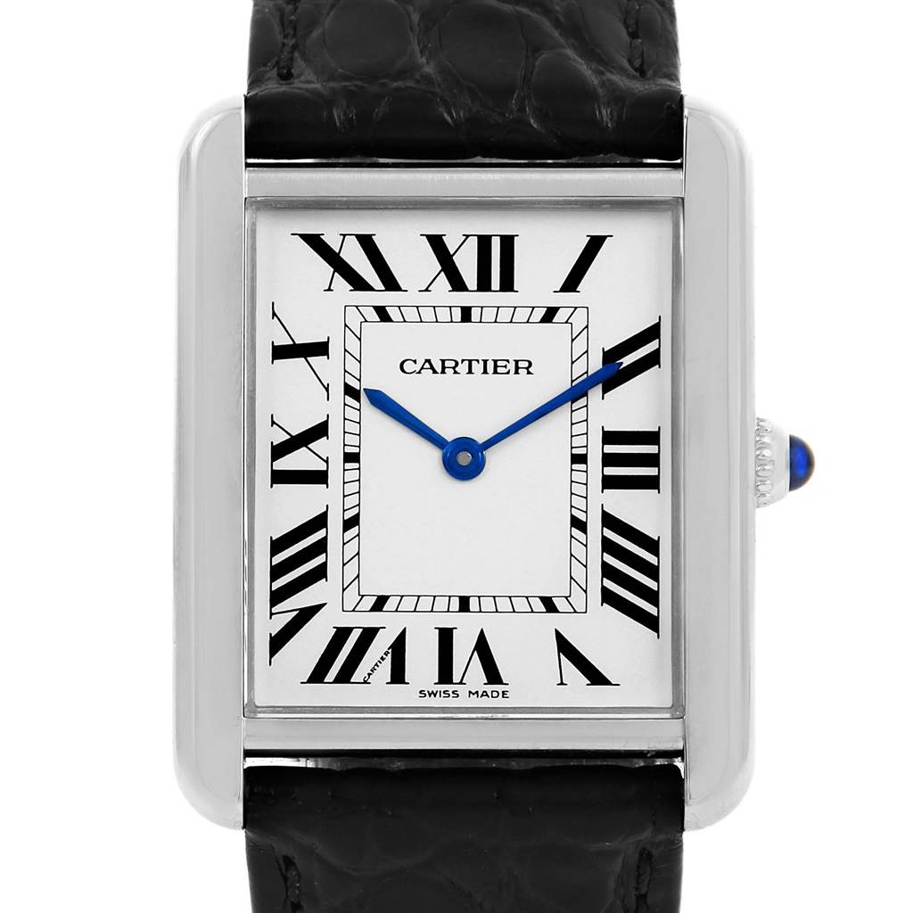 The image shows a close-up of the Cartier Tank Solo W1018355 Stainless Steel Silver Dial W1018355 Stainless Steel Silver Dial watch face, highlighting the Roman numerals, blue hands, and part of the black strap.