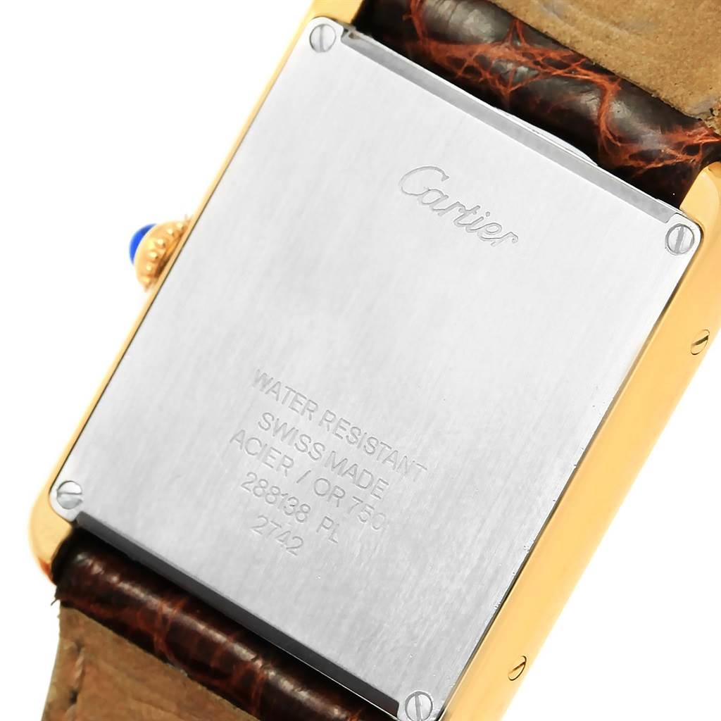 This image shows the back of a Cartier Tank Solo W1018855 Men
s Steel and Gold (two tone) Silver Dial W1018855 Men
s Steel and Gold (two tone) Silver Dial watch, highlighting the engraved details and leather strap.