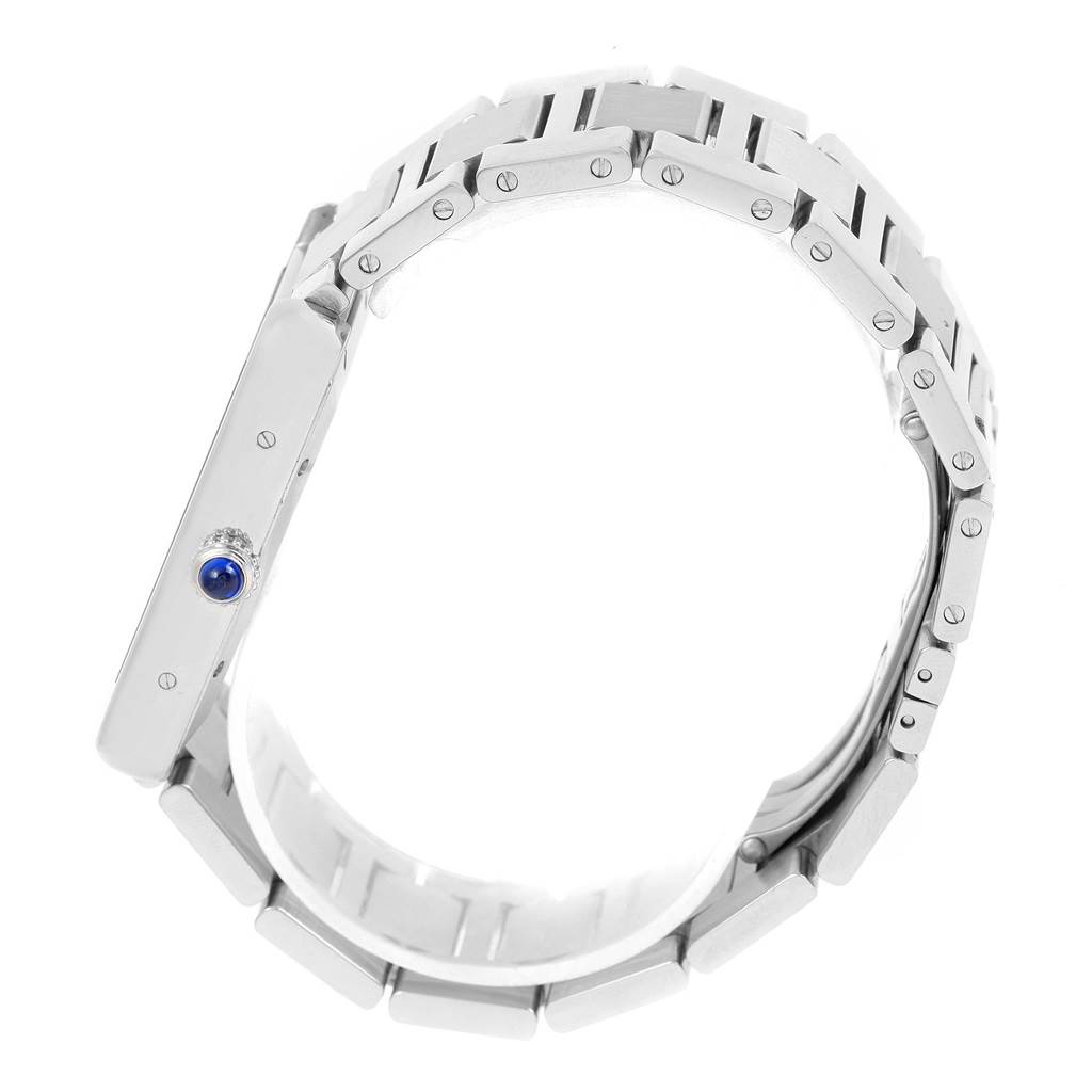 The image shows a side view of the Cartier Tank Solo W5200028 Men
s Stainless Steel Silver Dial W5200028 Men
s Stainless Steel Silver Dial watch, highlighting the crown with a blue cabochon and parts of the bracelet.